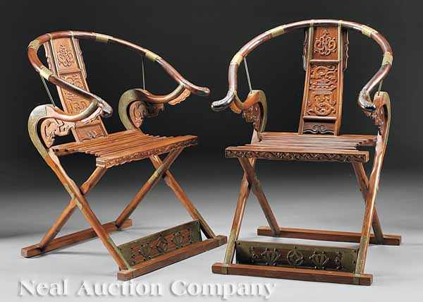 Appraisal: A Pair of Chinese Carved and Brass-Mounted Folding Horseshoeback Armchairs