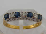 Appraisal: A sapphire and diamond half hoop ring the seven stones