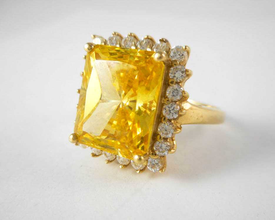 Appraisal: YELLOW CUBIC ZIRCOINA AND FOURTEEN KARAT GOLD RING with round-cut