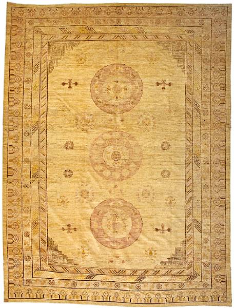 Appraisal: A Khotan carpet Turkestan The oatmeal field woven with three