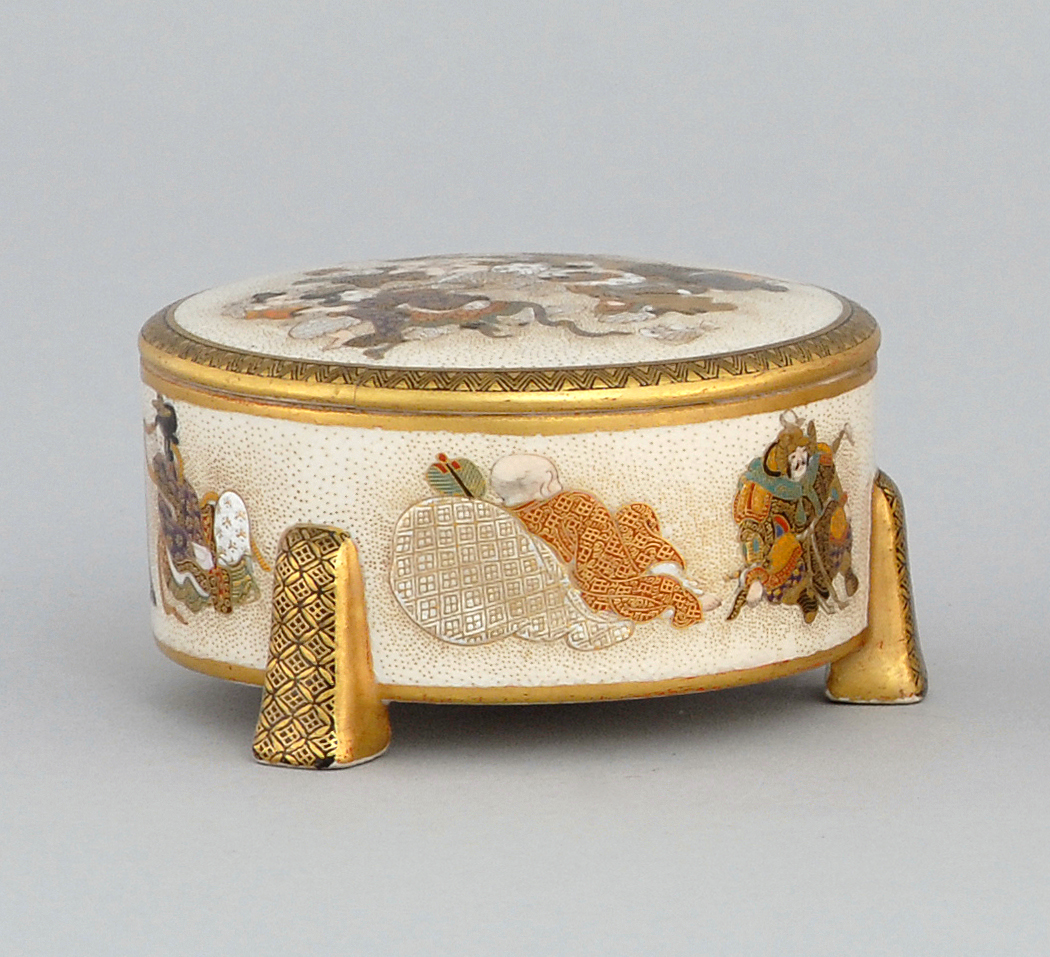 Appraisal: SATSUMA POTTERY BOX With Shinto god decoration and tripod base