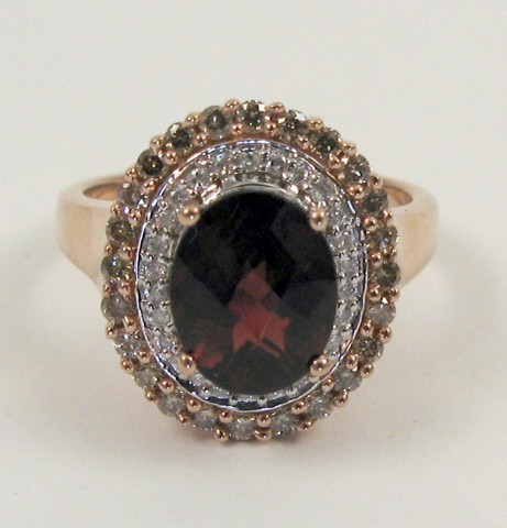 Appraisal: GARNET DIAMOND AND FOURTEEN KARAT GOLD RING centering an oval