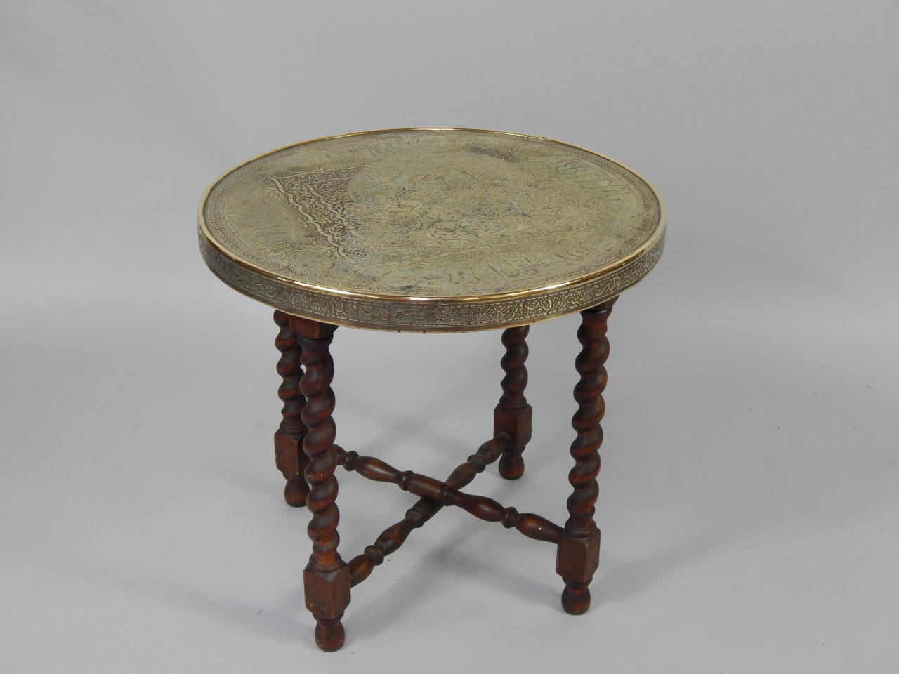 Appraisal: A Persian brass and oak folding occasional table the circular