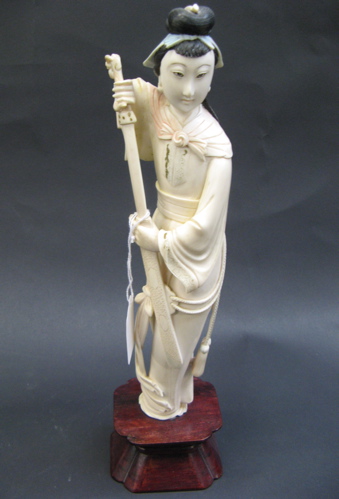 Appraisal: ELEPHANT IVORY HAND CARVED FIGURE OF WOMAN standing holding long