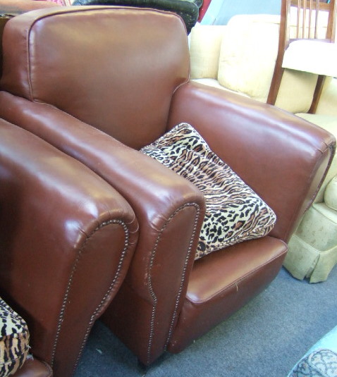 Appraisal: A pair of leather upholstered club armchairs of Art Deco