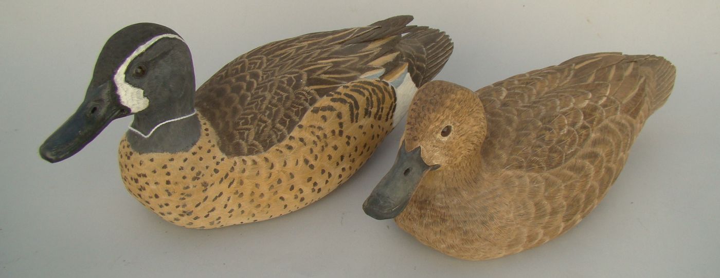 Appraisal: PAIR OF LIFE-SIZE BLUE-WINGED TEAL DECOYS Decoratively carved by Lewis