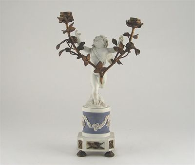 Appraisal: A S vres biscuit porcelain model of Cupid standing on