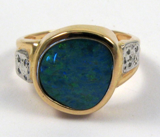 Appraisal: OPAL DIAMOND AND FOURTEEN KARAT GOLD RING four round-cut diamonds