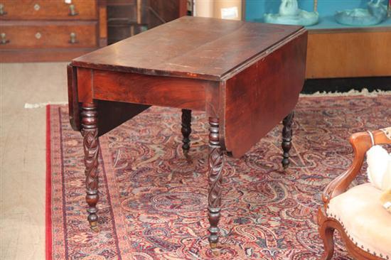 Appraisal: EMPIRE DROP LEAF TABLE Mahogany with shaped leaves on carved