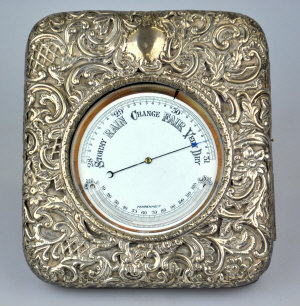 Appraisal: A silver and leather-bound goliath watch-case containing an aneroid barometer