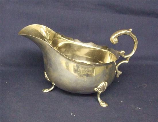 Appraisal: Edward VII silver sauce boat with scroll handle on three