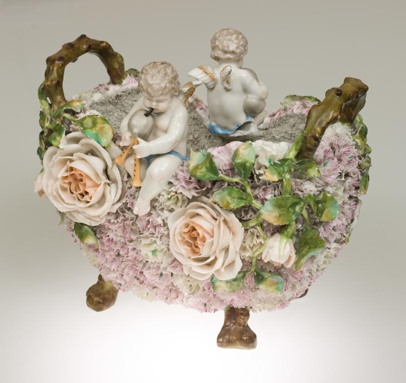 Appraisal: CONTINENTAL PORCELAIN FLORAL-ENCRUSTED TWIN-HANDLED FOOTED BOWL the shaped oval body