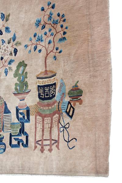 Appraisal: A Chinese rug decorated with urns and shrubs on a