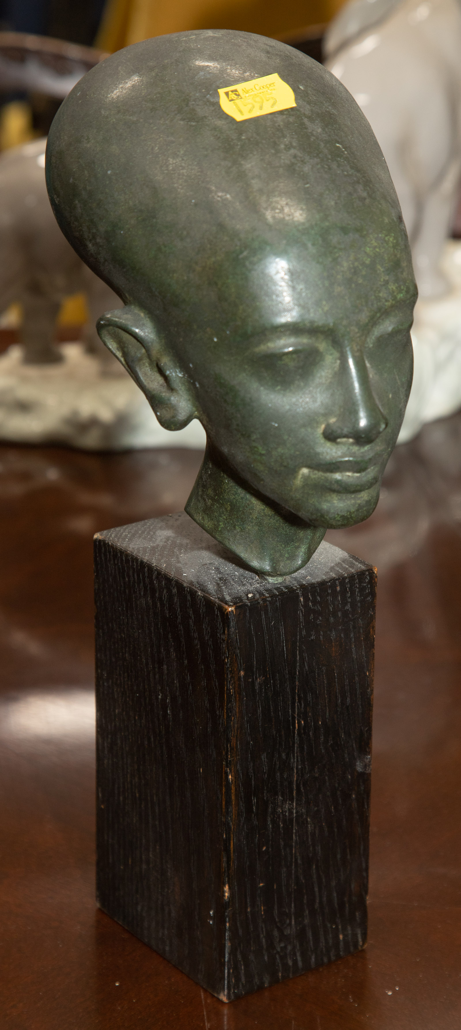 Appraisal: PATINATED BRONZE HEAD OF ANCIENT EGYPTIAN PRINCESS A daughter of