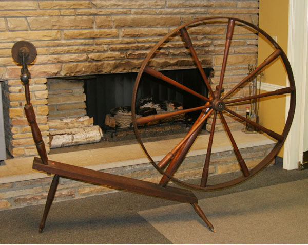 Appraisal: Large primitive wooden spinning wheel with shuttle H x L