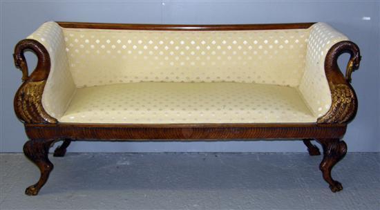 Appraisal: Early th century mahogany and parcel gilt sofa the scrolled