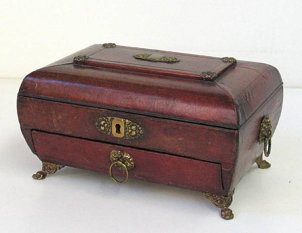 Appraisal: A Regency brass mounted leather sewing box of sarcophagus form