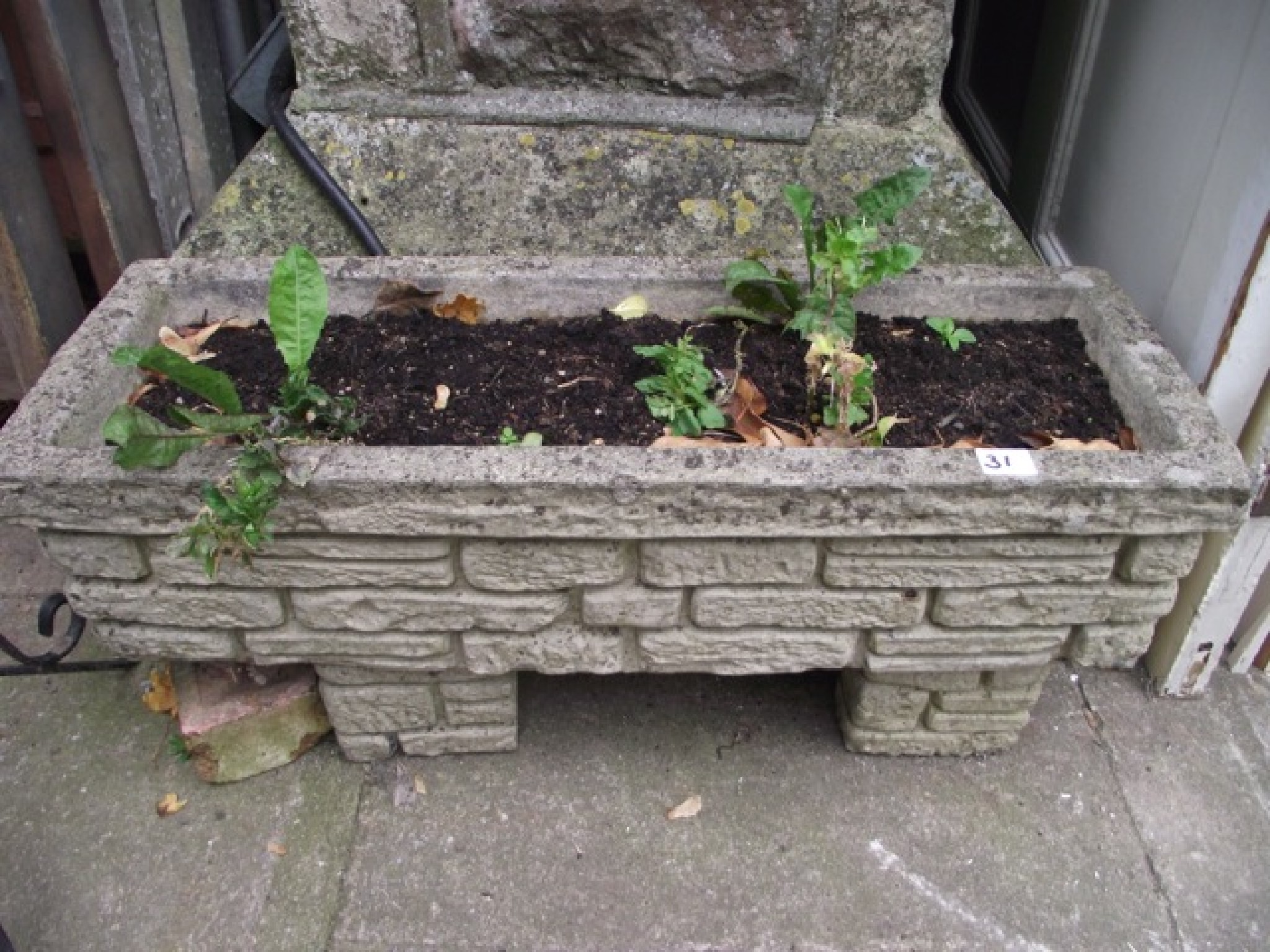 Appraisal: A weathered cast composition stone flower trough of rectangular form