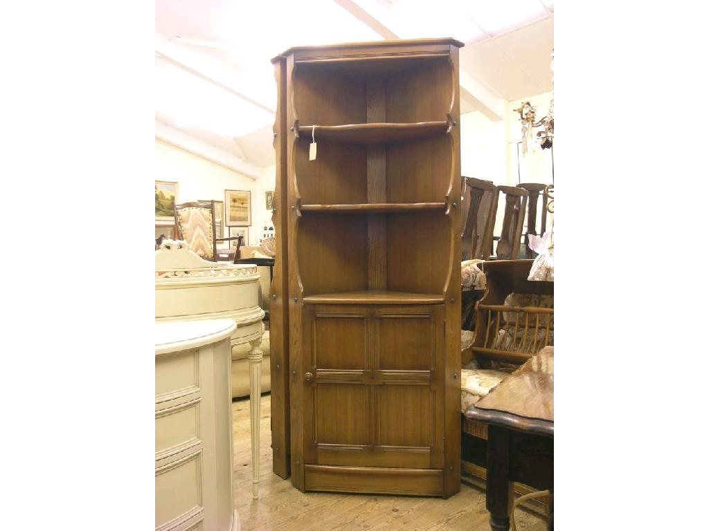 Appraisal: An Ercol medium elm floor-standing corner unit two open shelves