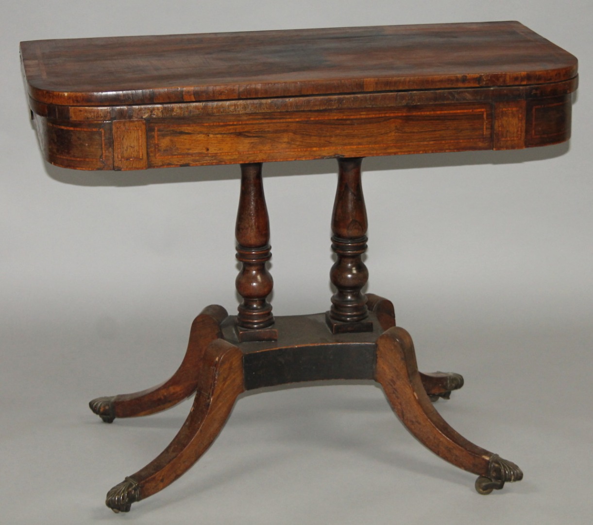 Appraisal: A Regency rosewood D-end games table the top with a