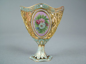 Appraisal: A gold and enamel 'Zarf' With three pierced filigree panels