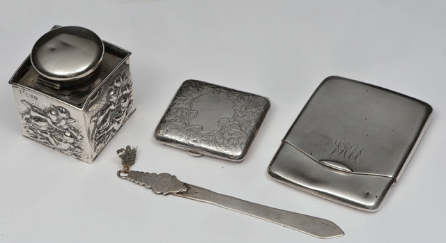 Appraisal: A SILVER CASED GLASS INKWELL square shaped with putti decoration