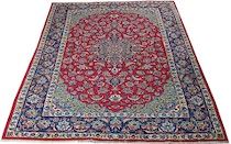 Appraisal: A Traditional Isphahan Carpet A dark blue floral medallion woven