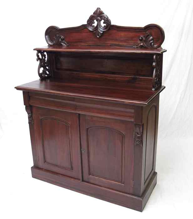 Appraisal: EMPIRE STYLE SIDEBOARD Shaped and carved backsplash over a two