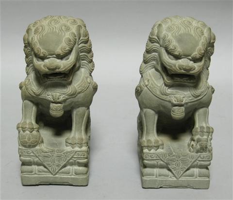 Appraisal: PAIR OF BUDDHISTIC LIONS Each of traditional form seated atop