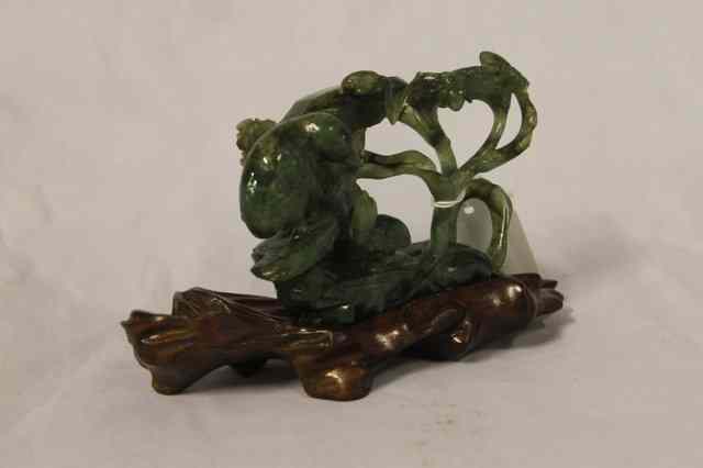 Appraisal: A CHINESE CARVED JADEITE MODEL OF A BIRD and chick