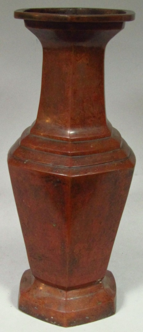 Appraisal: A thC bronze vase the stepped octagonal shouldered body surmounted