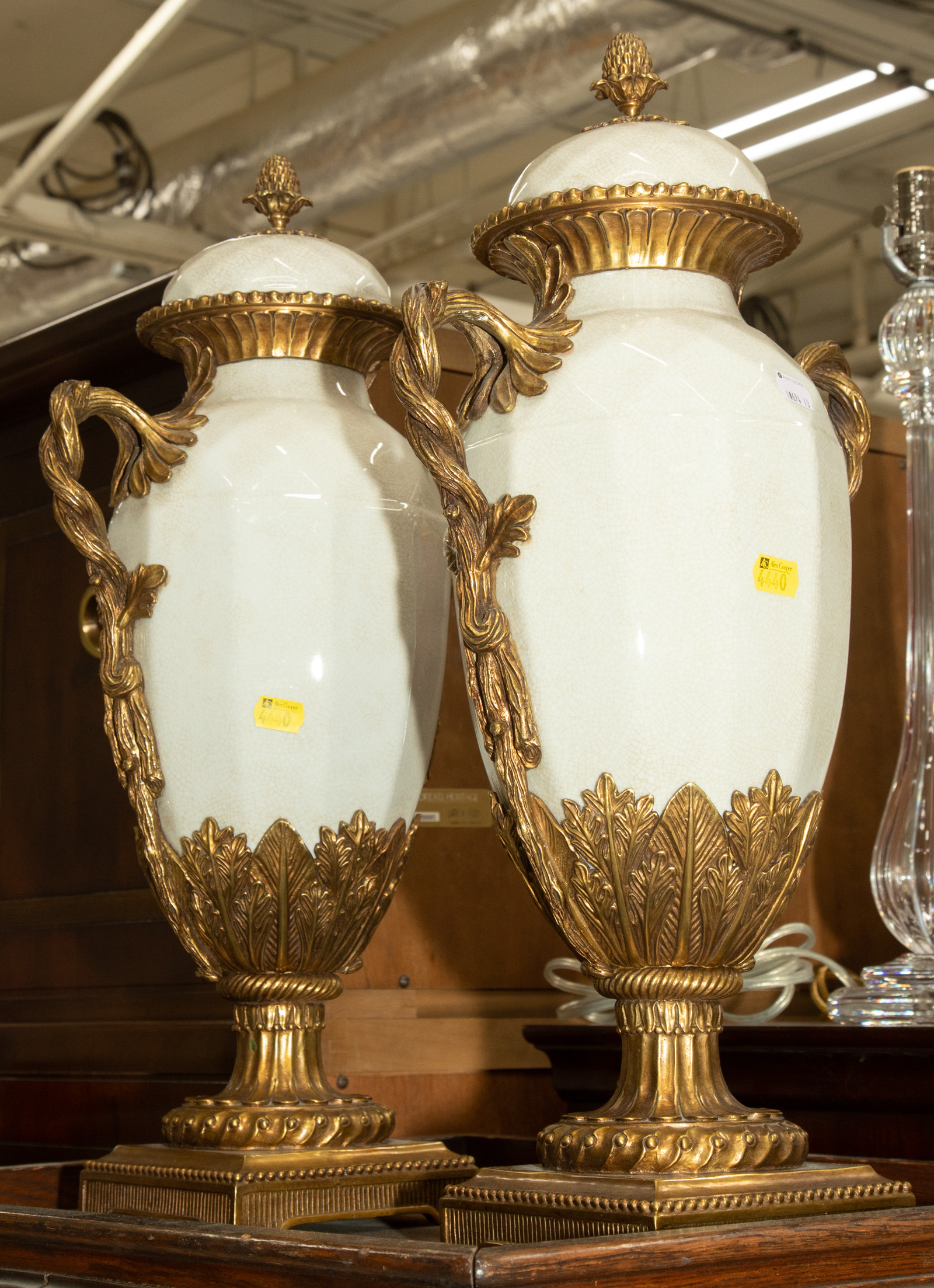 Appraisal: A PAIR OF ORMOLU MOUNTED PORCELAIN URNS Modern approximately in