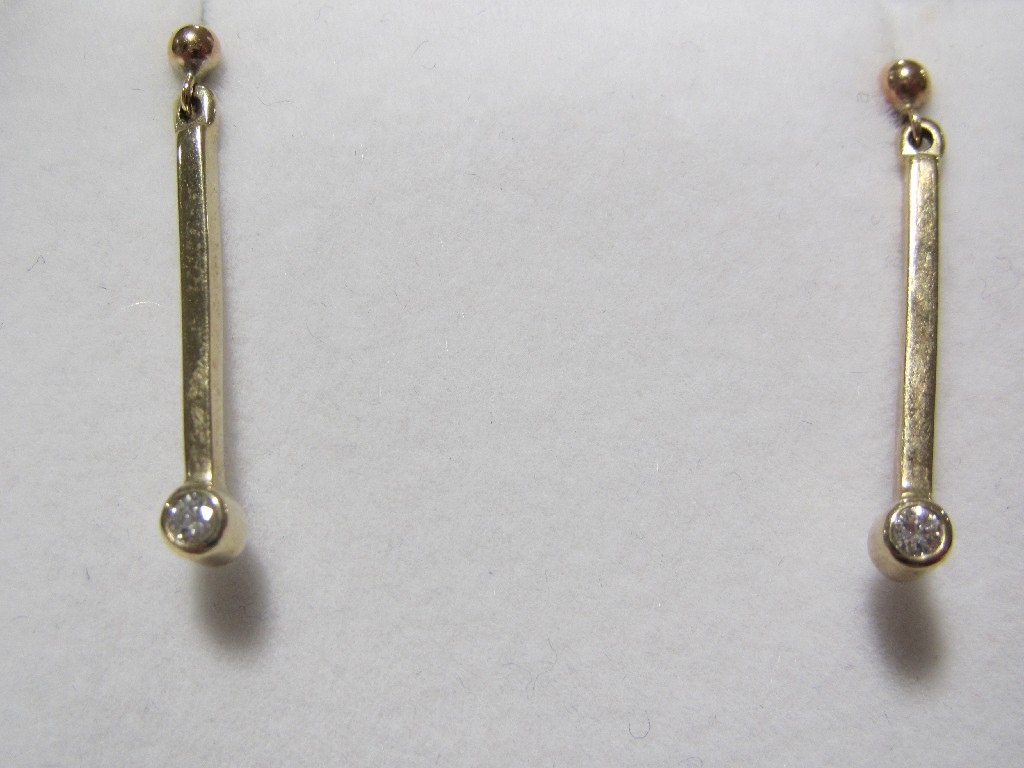 Appraisal: Nine carat gold collett set diamond drop earrings