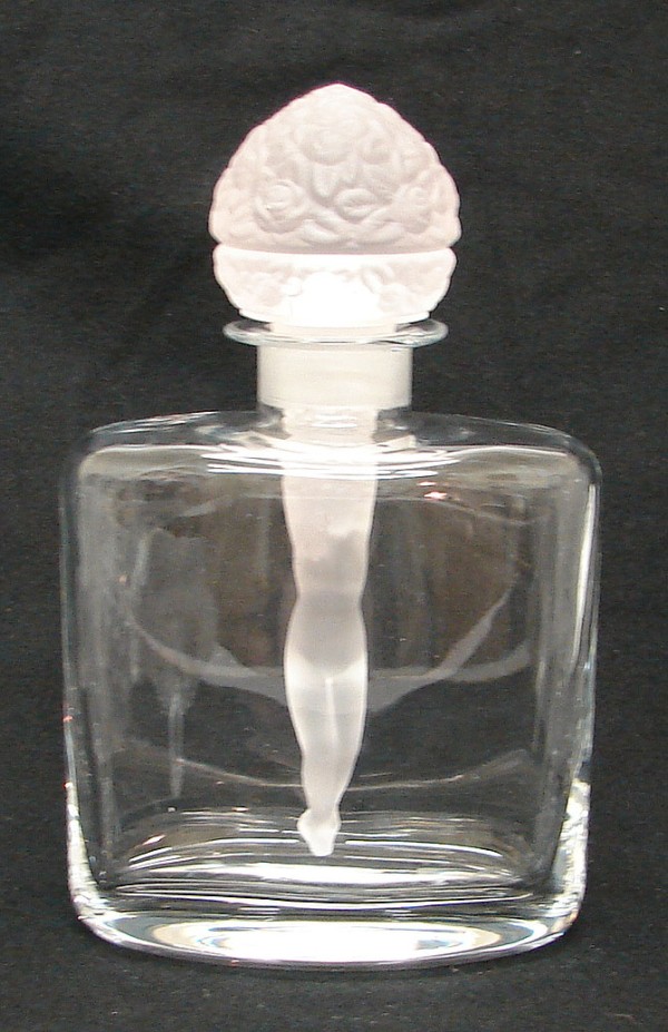 Appraisal: Clear perfume bottle features a large floral stopper with nude