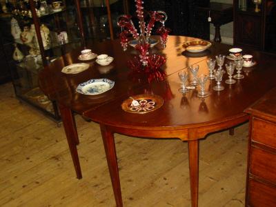 Appraisal: A GEORGE III MAHOGANY DINING TABLE c comprising two D