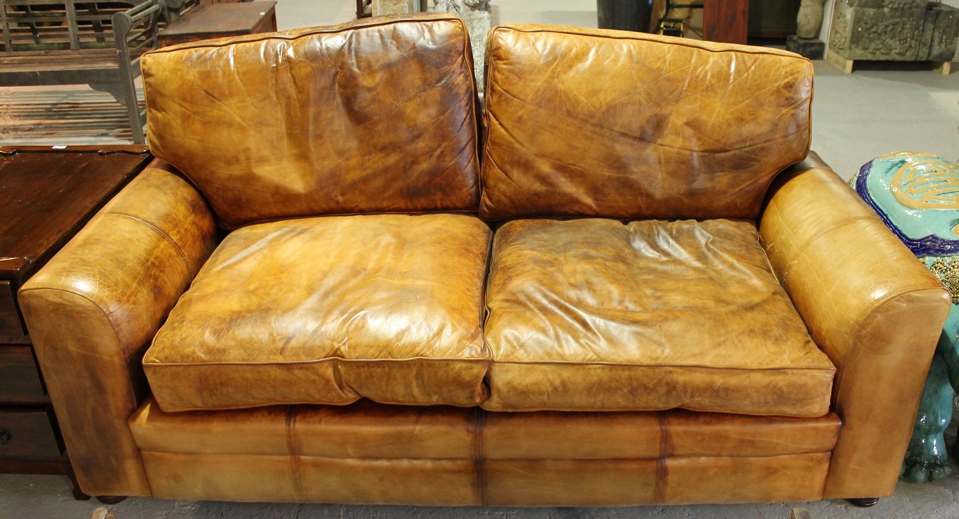 Appraisal: A pair of th century tan leather square back sofas