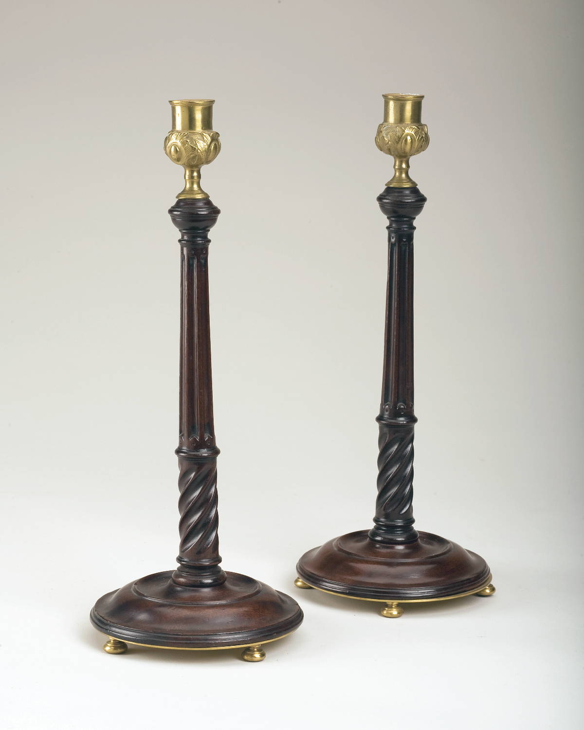 Appraisal: PAIR OF GEORGIAN MAHOGANY AND BRASS CANDLESTICKS Height inches Now