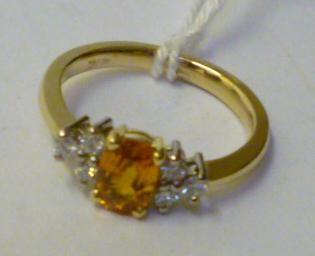 Appraisal: A YELLOW SAPPHIRE AND DIAMOND DRESS RING the oval faceted