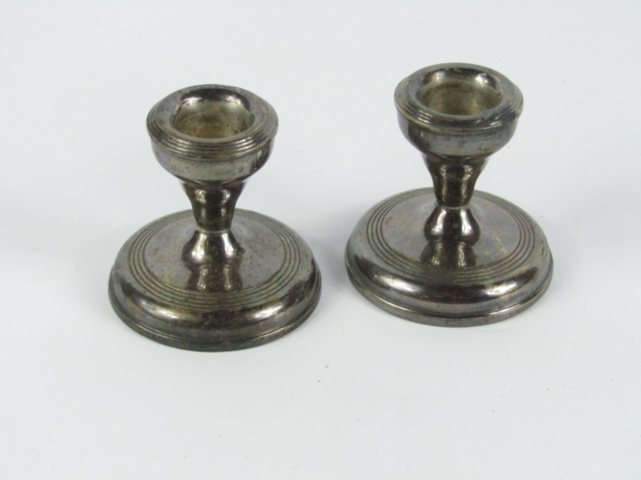 Appraisal: A pair of George IV silver loaded candlesticks Birmingham cm