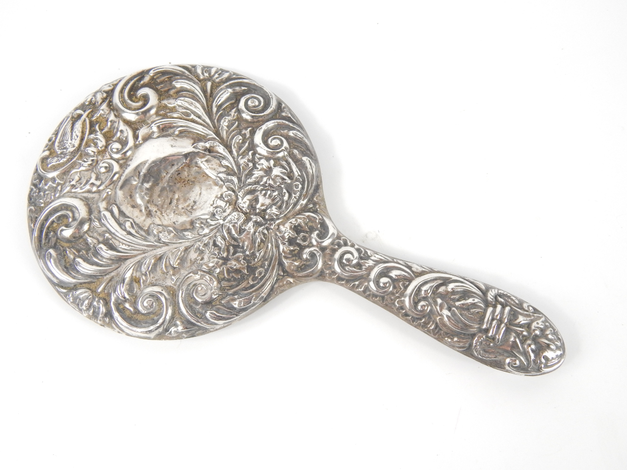 Appraisal: A silver hand mirror embossed with masks birds and foliate