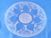 Appraisal: A moulded glass plate with raised frosted floral pattern the