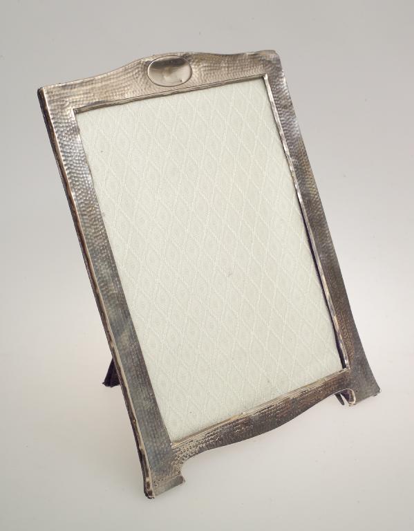 Appraisal: EDWARDIAN SILVER PHOTOGRAPH FRAME BIRMINGHAM of shaped rectangular easel form