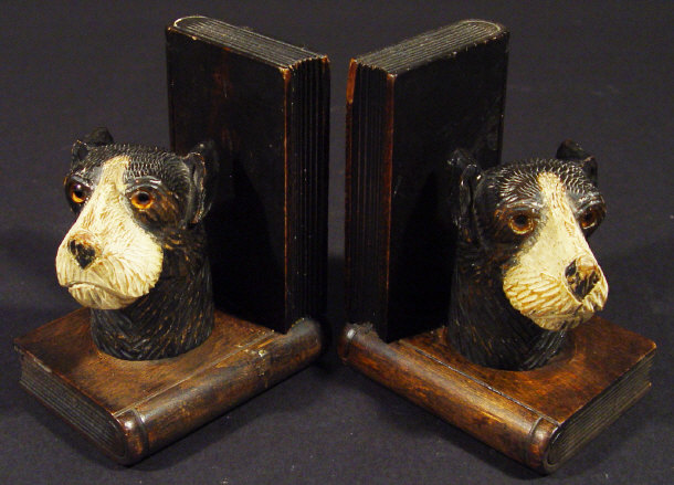 Appraisal: Pair of mahogany bookends mounted with carved black forest style