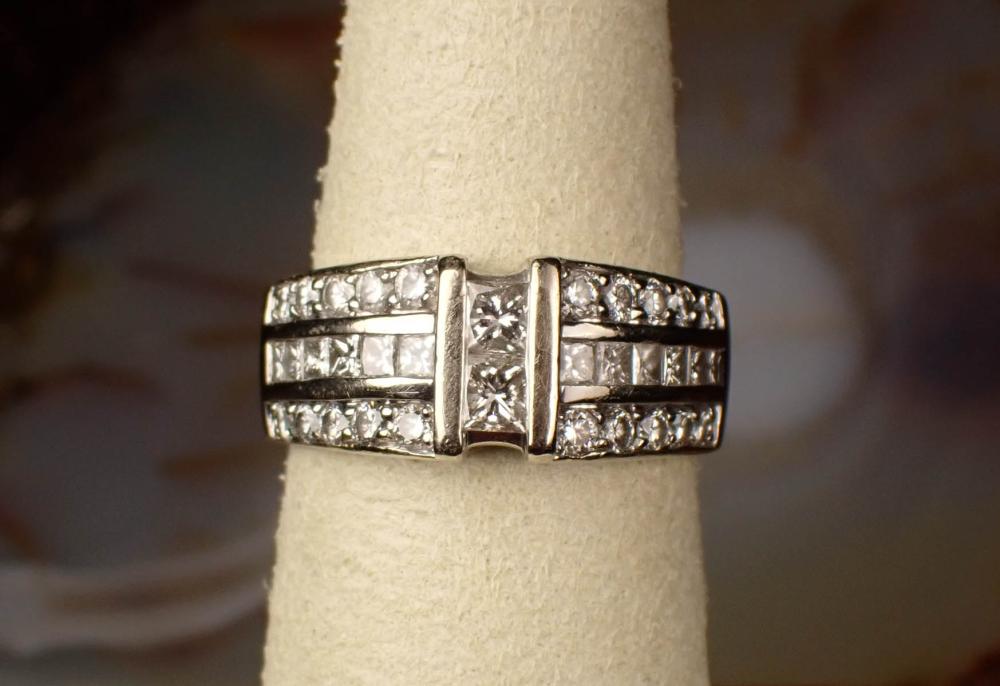 Appraisal: DIAMOND AND FOURTEEN KARAT WHITE GOLD RING with six princess-cut