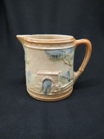 Appraisal: Roseville Pottery Slip Decorated Pitcher raised landscape with bridges tall