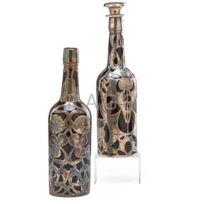 Appraisal: SILVER OVERLAY BOTTLES Two in amber glass early th c