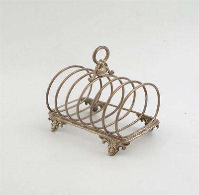 Appraisal: A Victorian toast rack with ornate feet and handle and