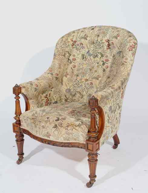 Appraisal: A VICTORIAN WALNUT FRAMED BUTTON BACKED ARMCHAIR the arms with