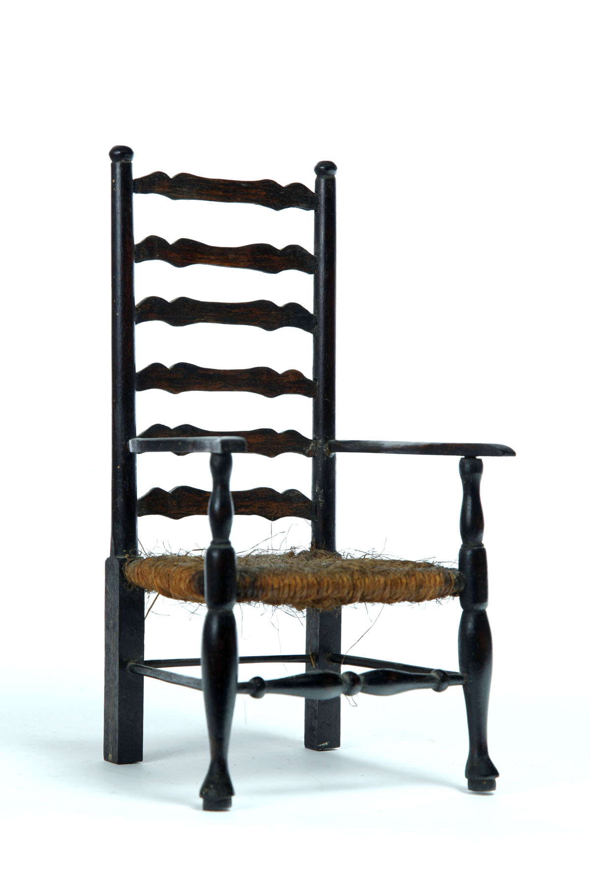 Appraisal: MINIATURE LADDERBACK ARMCHAIR American late th century mixed woods including