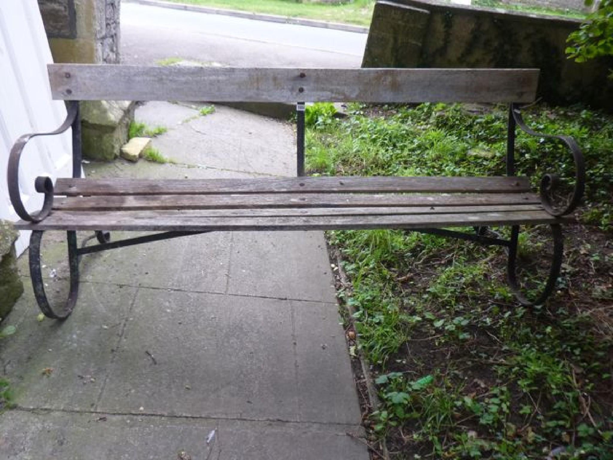 Appraisal: A sprung steel garden bench with weathered slatted seat and